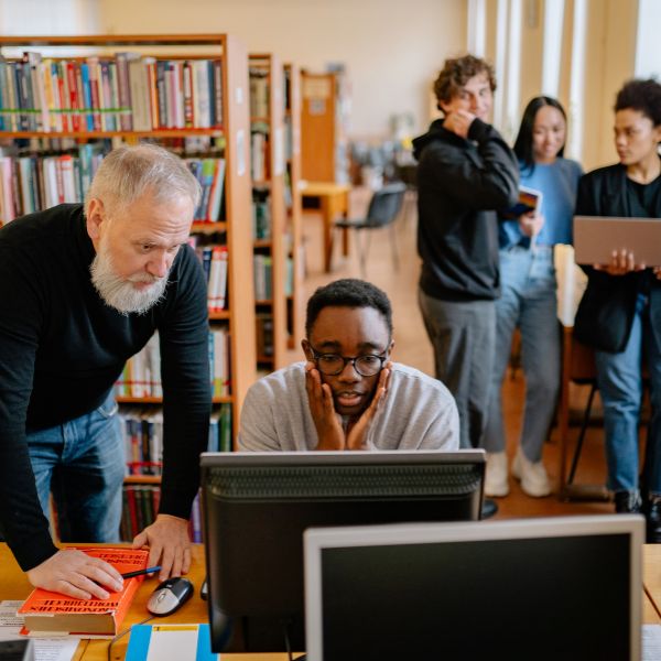 student and professor on computer